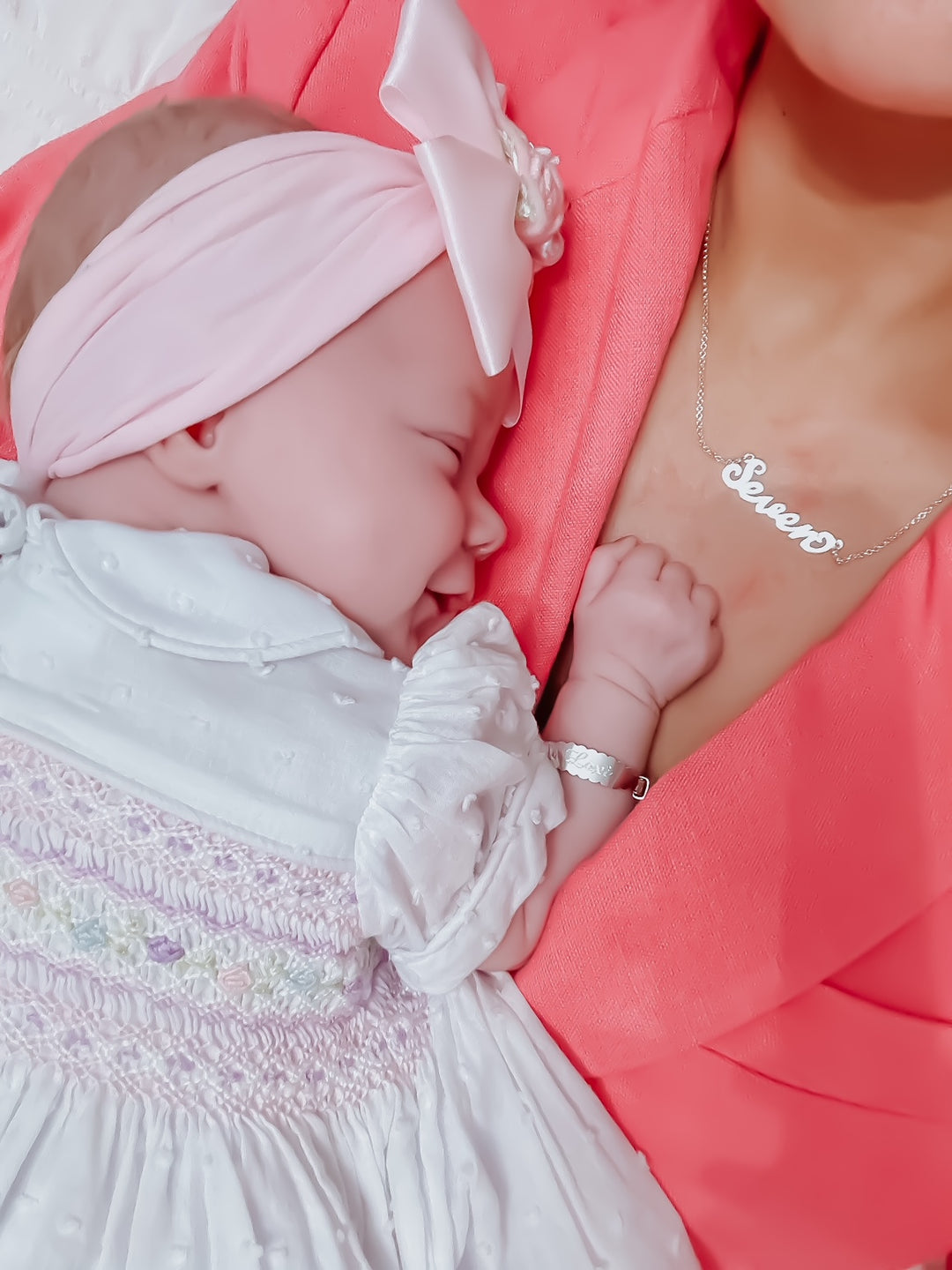 Mother and baby hugging wearing personalised engraved jewellery bangle and necklace