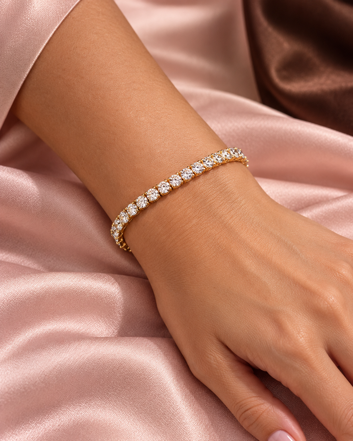 Classic yellow-gold tennis bracelet worn on wrist