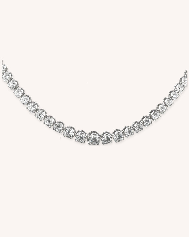 Graduated Crown-Set Lab-Grown Diamond Tennis Necklace in 9ct White Gold on cream background #metal_9ct-white-gold