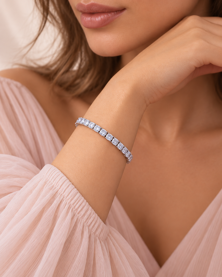 Crown-set tennis bracelet worn by elegant model, lips and chin only, portrait
