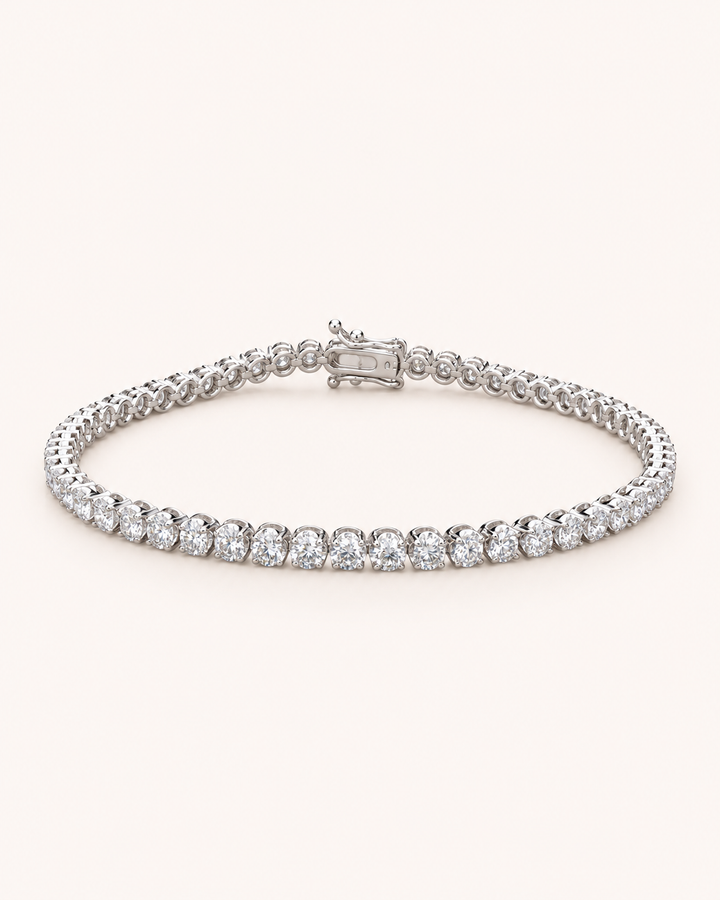 Crown-set lab-grown diamond tennis bracelet on soft ivory background