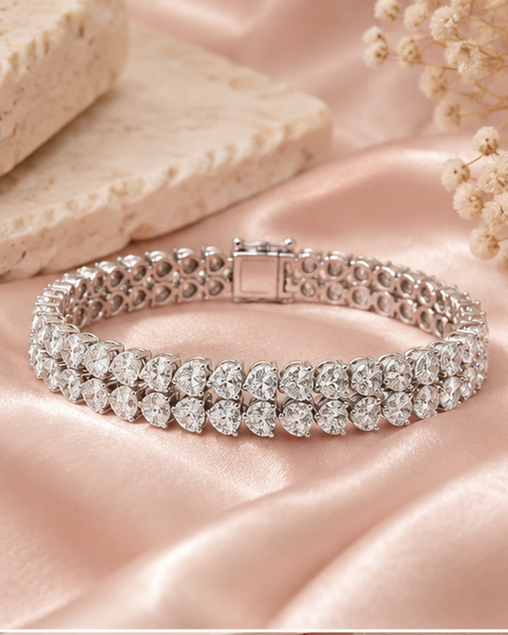 Double row pear shape lab-grown diamond tennis bracelet on soft blush satin