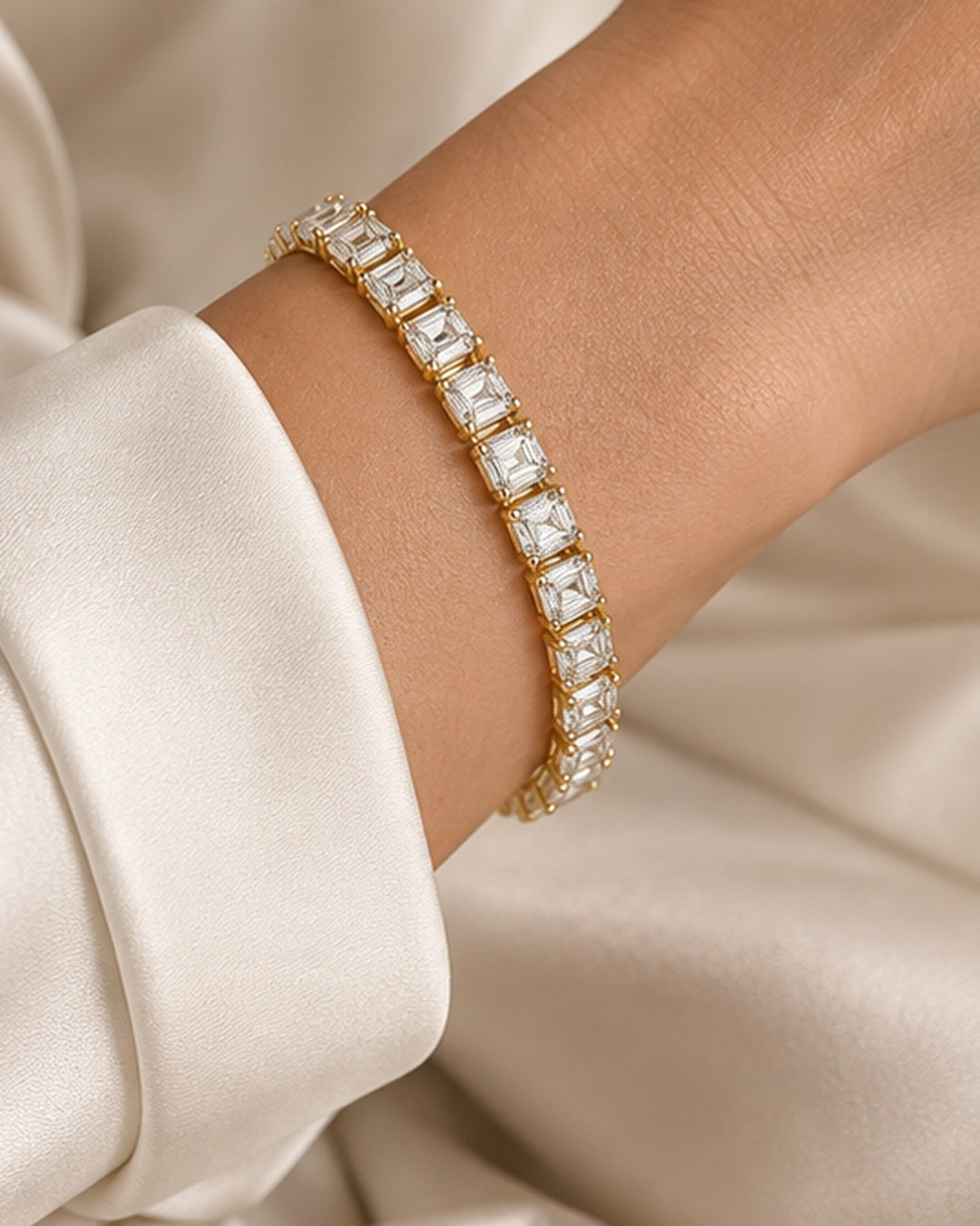 Emerald cut lab-grown diamond tennis bracelet in 9ct yellow gold worn on wrist
