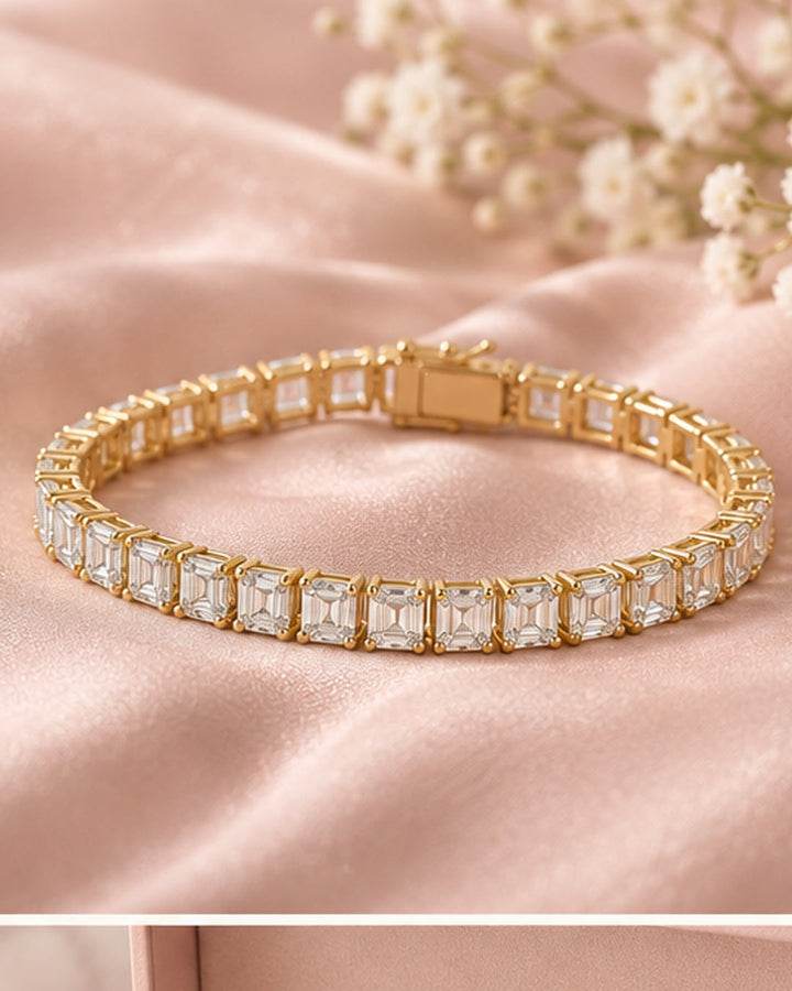 Emerald cut lab-grown diamond tennis bracelet in 9ct yellow gold on blush satin
