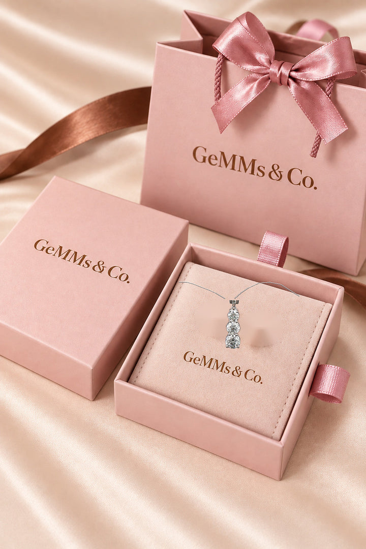 2.24ct white-gold trilogy lab-grown diamond pendant and illustrative chain shown in GeMMs & Co luxury packaging, styled mockup #metal_9ct-white-gold