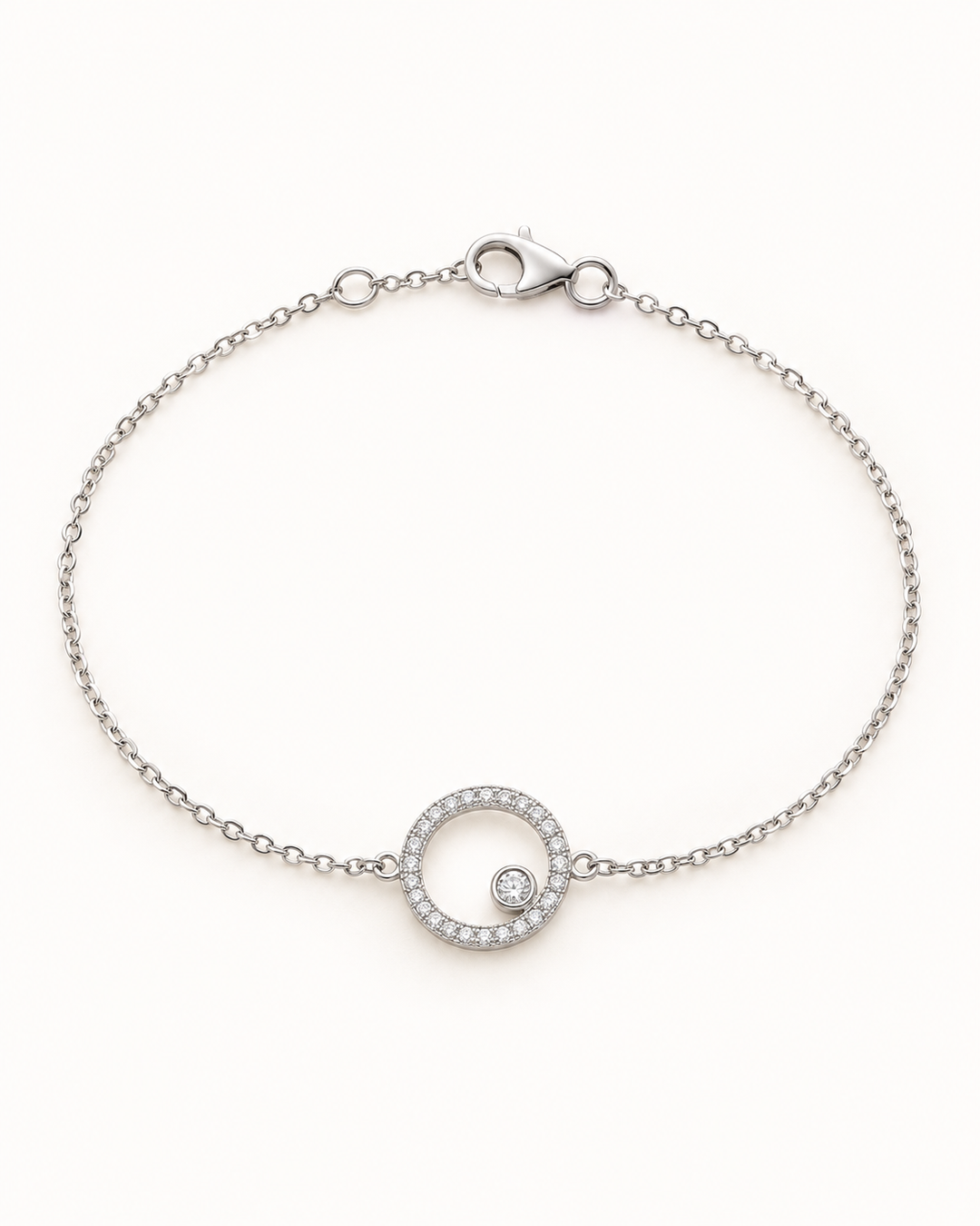 Styled illustration of silver Circle of Life CZ chain bracelet arranged in an oval on a white background