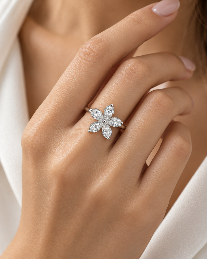 Five pear-shaped lab-grown diamond petals flower ring worn on model hand in 18ct white gold — illustrative lifestyle image