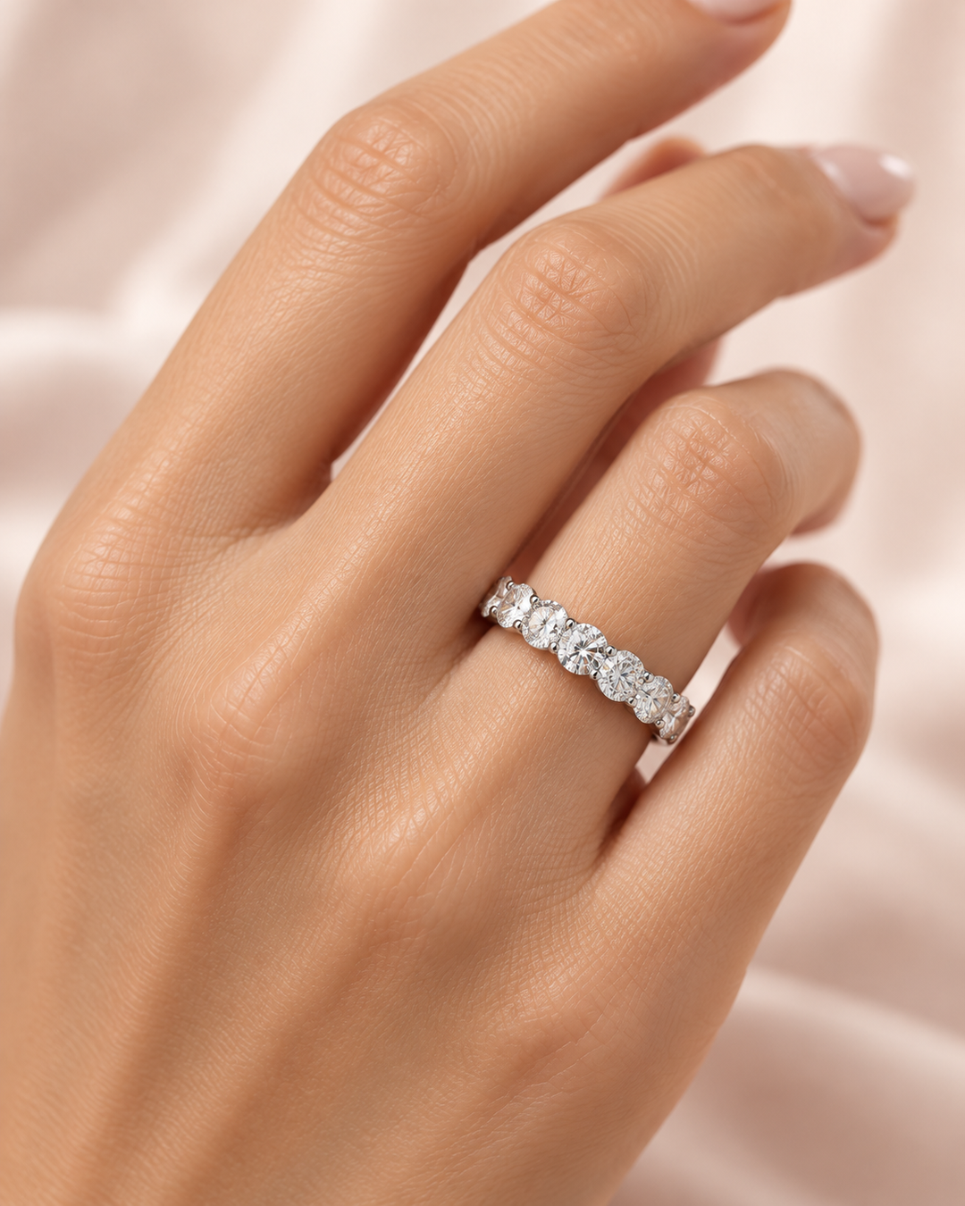 Model hand wearing GeMMs & Co 9ct white gold lab-grown diamond round half eternity ring — illustrative lifestyle photograph #metal_9ct-white-gold