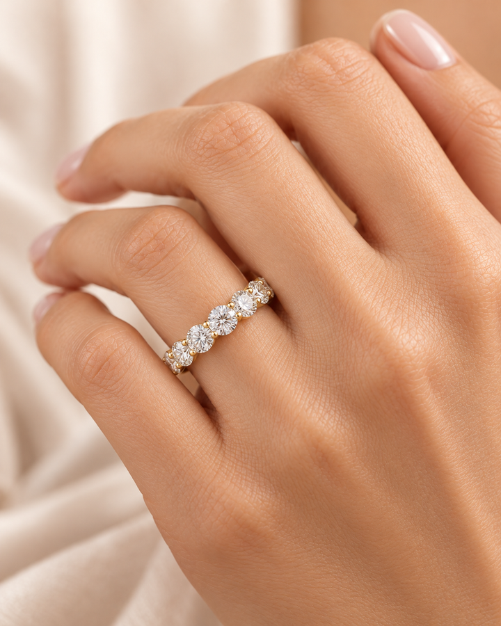 Model hand wearing GeMMs & Co 9ct yellow gold lab-grown diamond round half eternity ring — illustrative lifestyle photograph #metal_9ct-yellow-gold