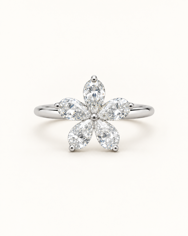Five-petal pear-shaped lab-grown diamond flower ring in 18ct white gold on cream — illustrative product render