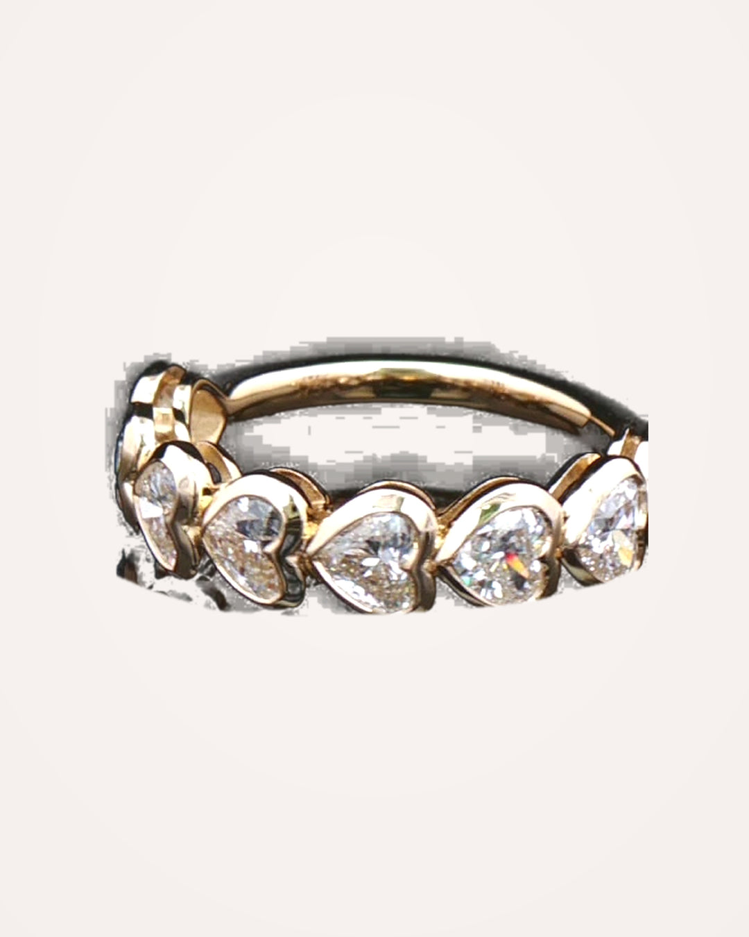 Yellow-gold heart-cut diamonds and settings close up #metal_9ct-yellow-gold