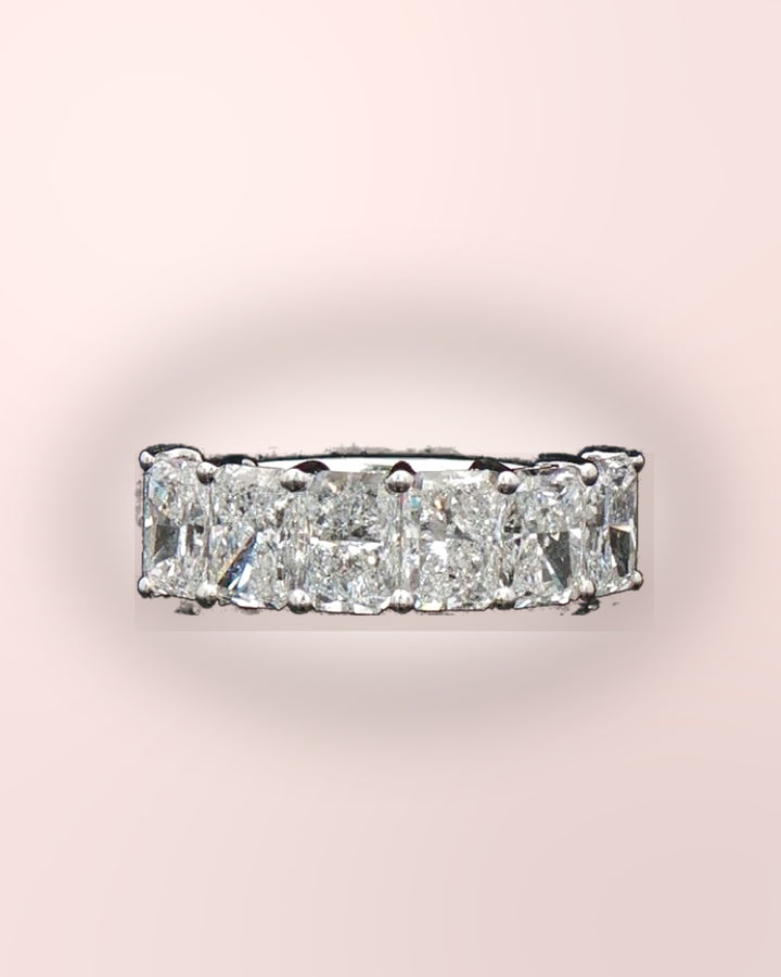 Sparkling radiant-cut diamond half eternity ring styled on blush #metal_9ct-white-gold