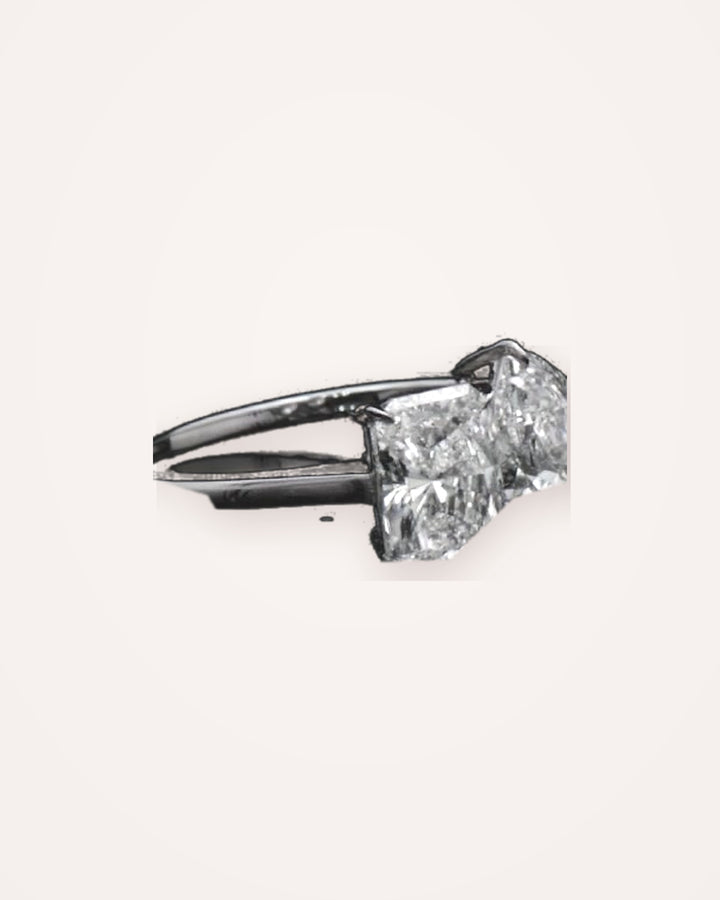 Toi et Moi ring angled setting view from LMJ film #metal_18ct-white-gold
