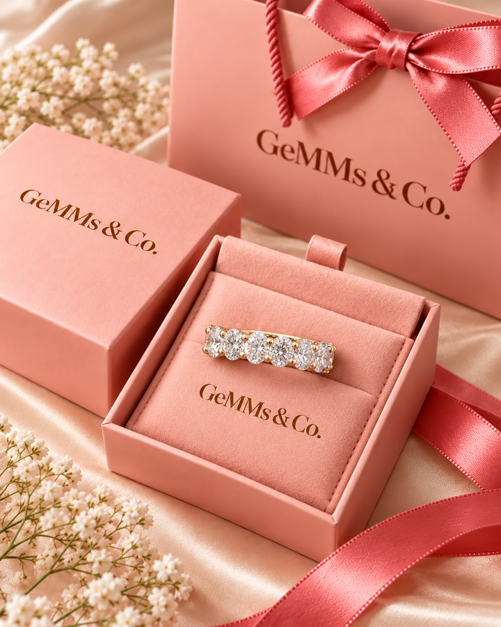 Round lab-grown diamond half eternity ring in 9ct yellow gold inside GeMMs & Co pink luxury gift packaging — AI-styled photograph #metal_9ct-yellow-gold