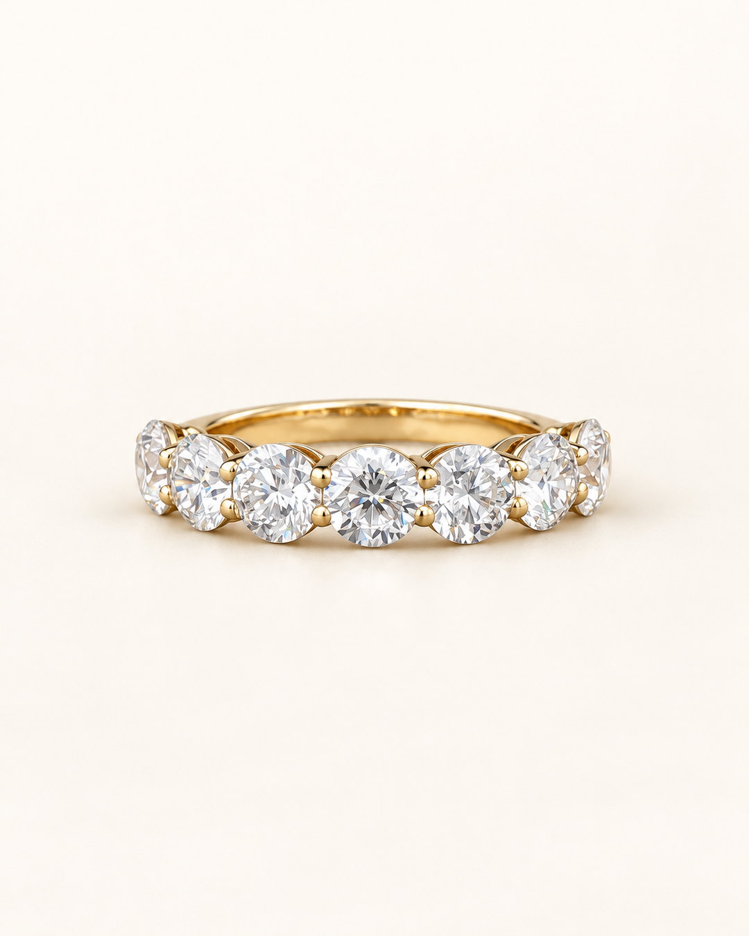 Lab-grown diamond round half eternity ring in 9ct yellow gold on cream, styled product image #metal_9ct-yellow-gold