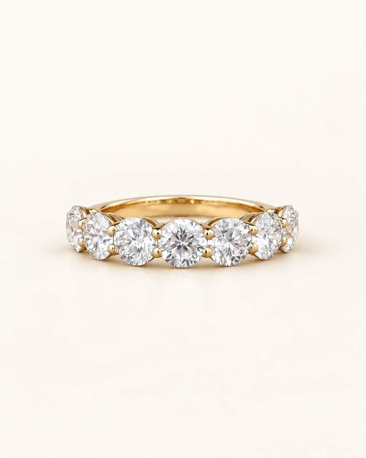 Lab-grown diamond round half eternity ring in 9ct yellow gold on cream, styled product image #metal_9ct-yellow-gold