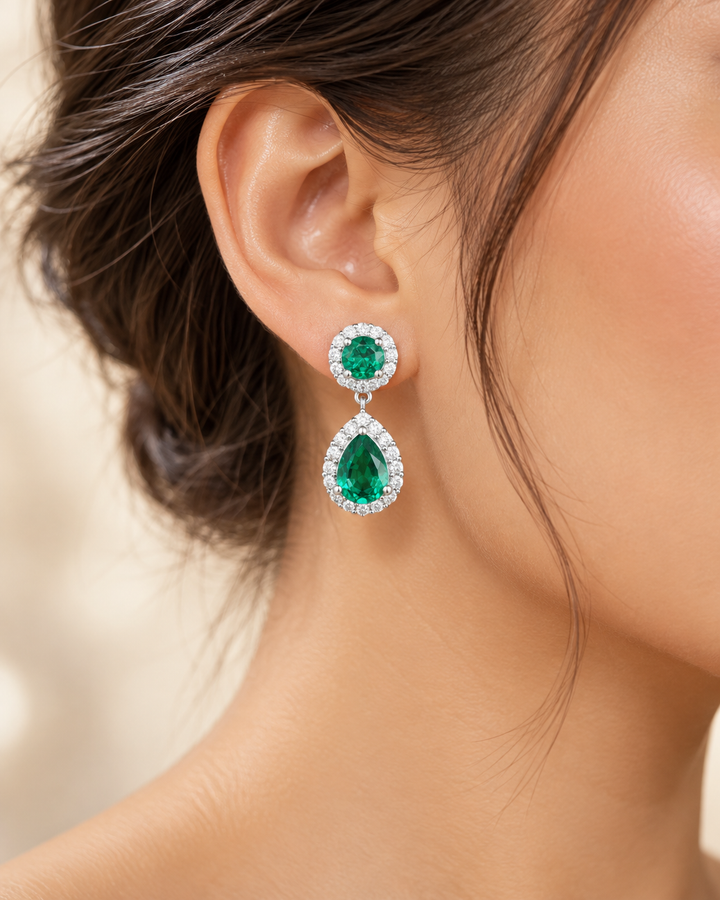 Green halo pear drop earrings — realistic on-ear portrait image
