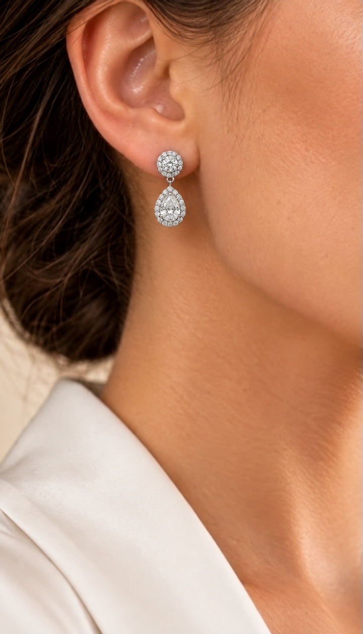 18ct white gold lab-grown diamond halo pear drop earrings on model — approximately 2.60ct total per pair #metal_18ct-white-gold