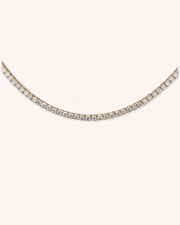 Three-Prong Lab-Grown Diamond Tennis Necklace in 18ct Yellow Gold on cream background #metal_18ct-yellow-gold