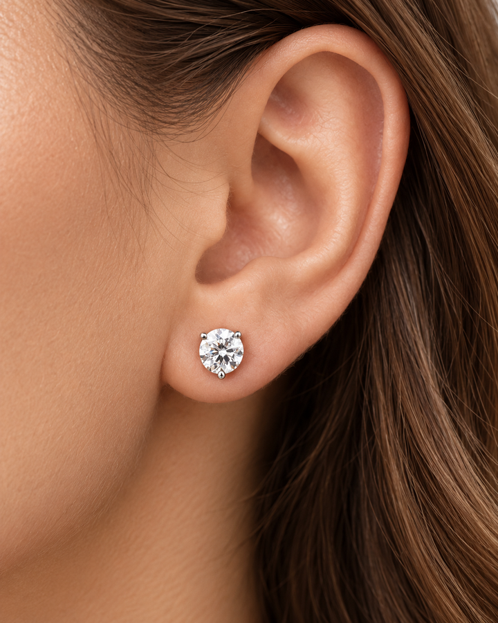 IGI-certified martini lab-grown diamond stud earrings in 9ct white gold worn on ear #metal_9ct-white-gold