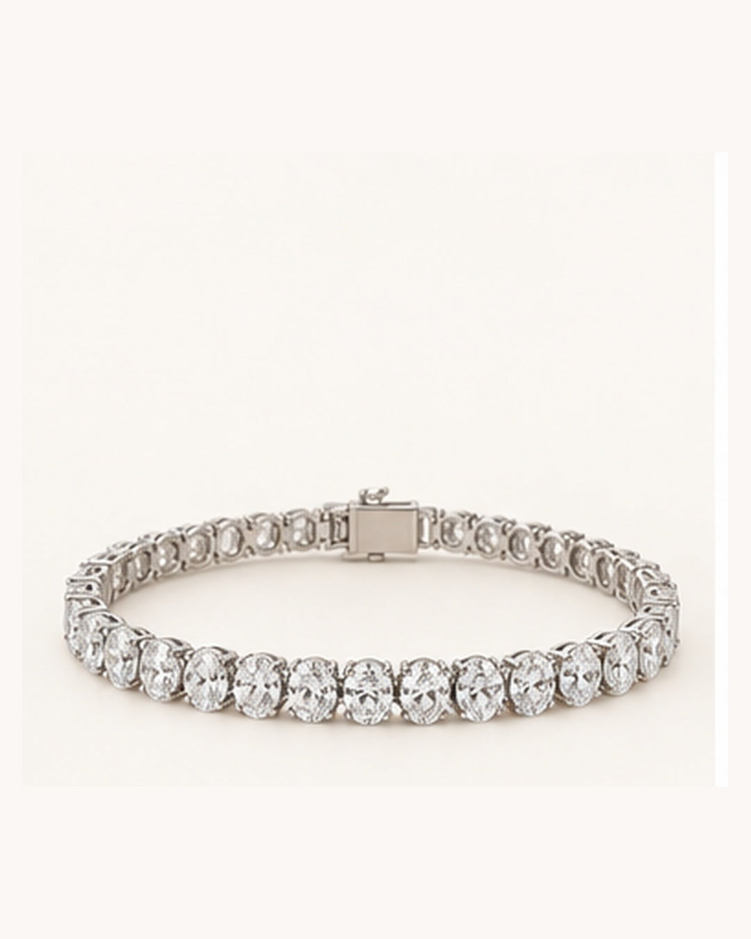Oval cut lab-grown diamond tennis bracelet on cream background
