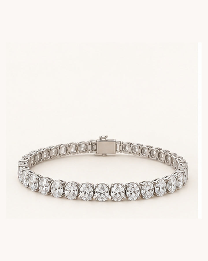 Oval cut lab-grown diamond tennis bracelet on cream background
