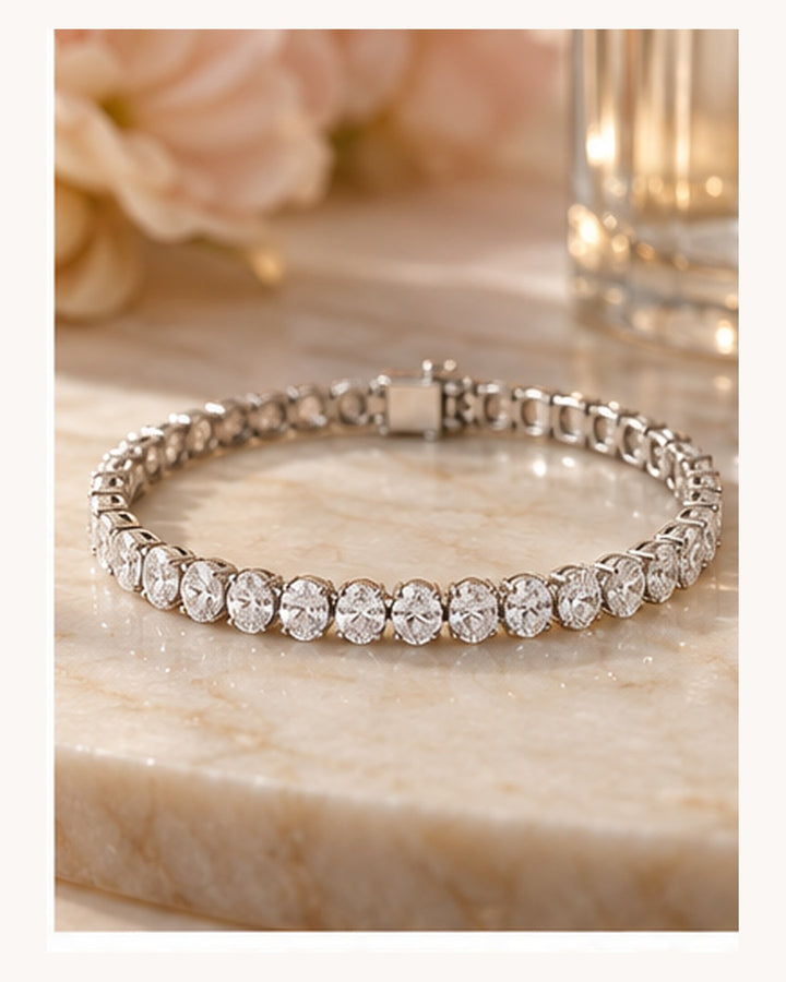 Oval cut lab-grown diamond tennis bracelet styled on a soft neutral background