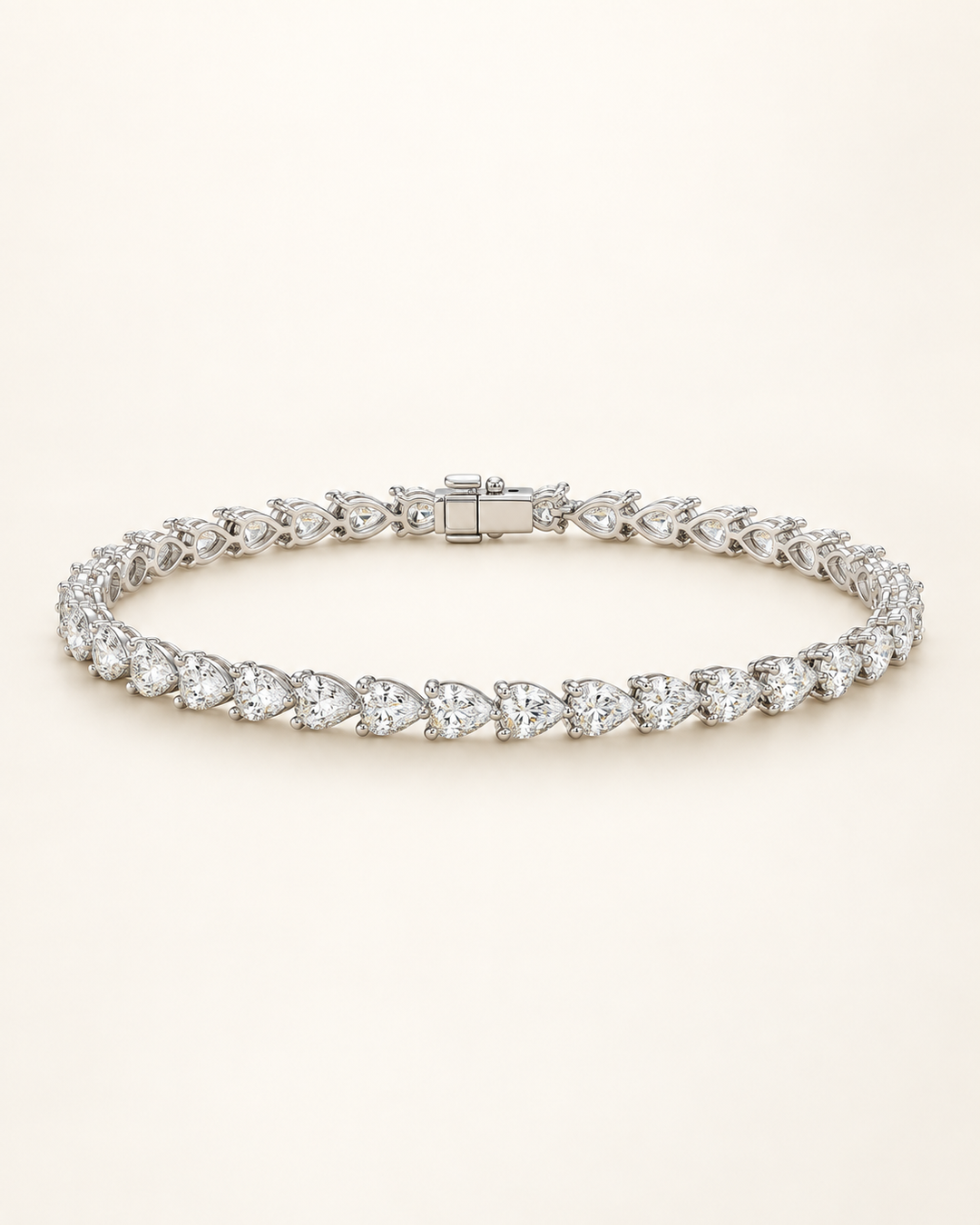 Pear shape lab-grown diamond tennis bracelet on cream background