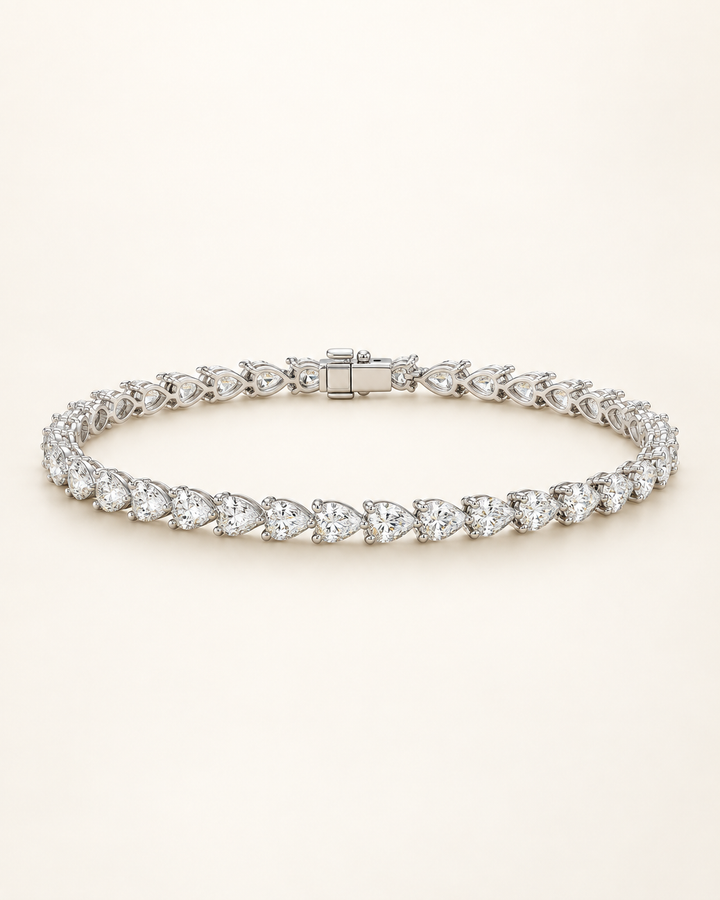 Pear shape lab-grown diamond tennis bracelet on cream background