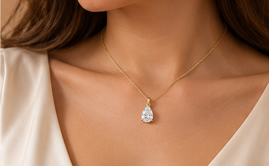 Pear-cut solitaire pendant necklace worn on model #metal_9ct-yellow-gold