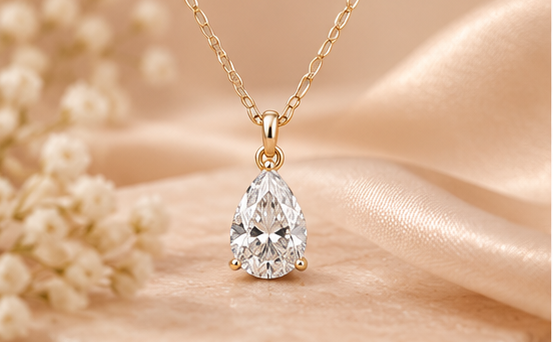 Pear-cut solitaire pendant necklace styled image #metal_9ct-yellow-gold
