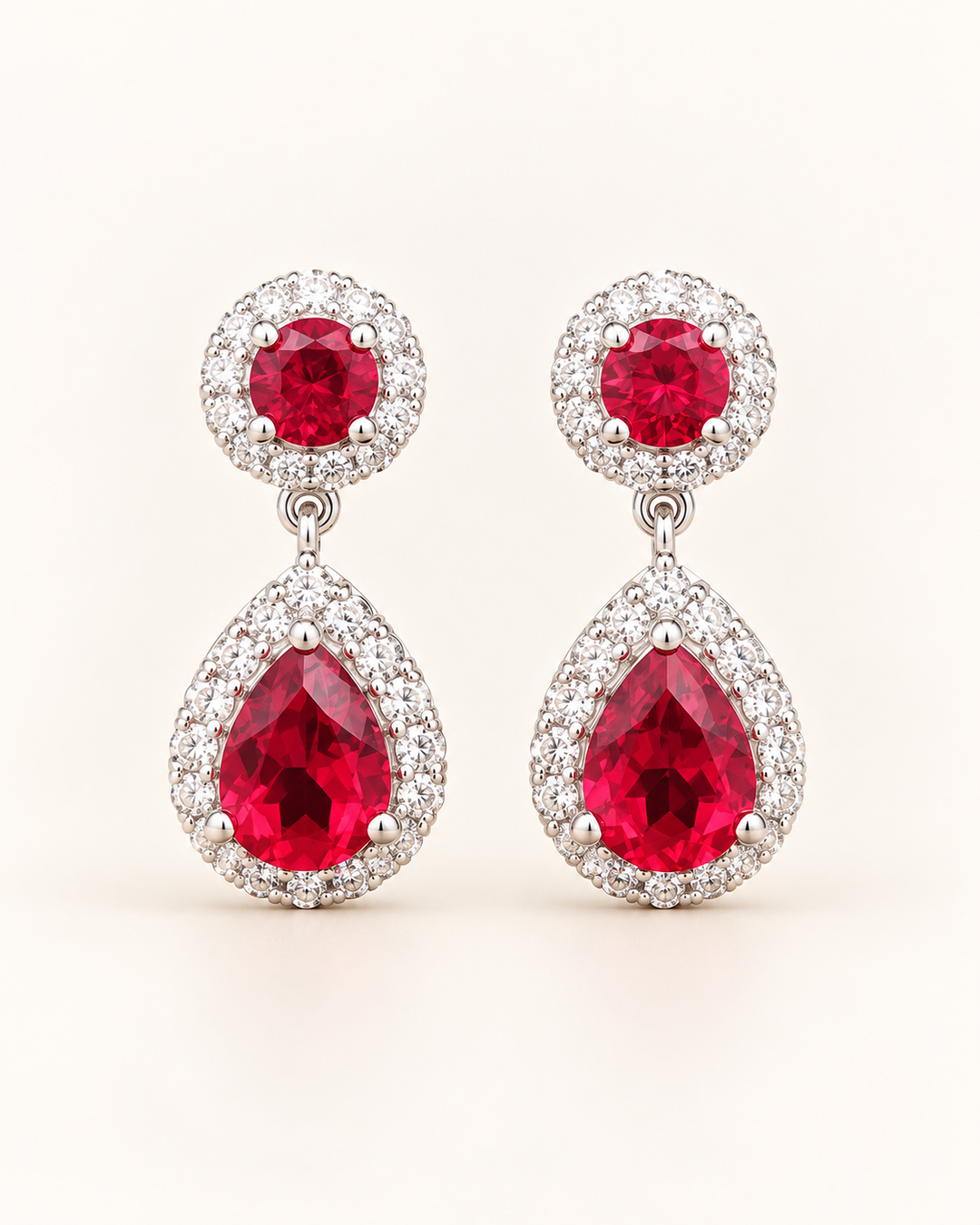 Red halo pear drop earrings — clean cream portrait product image