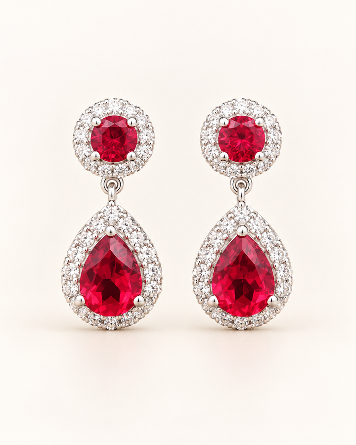 Red halo pear drop earrings — clean cream portrait product image