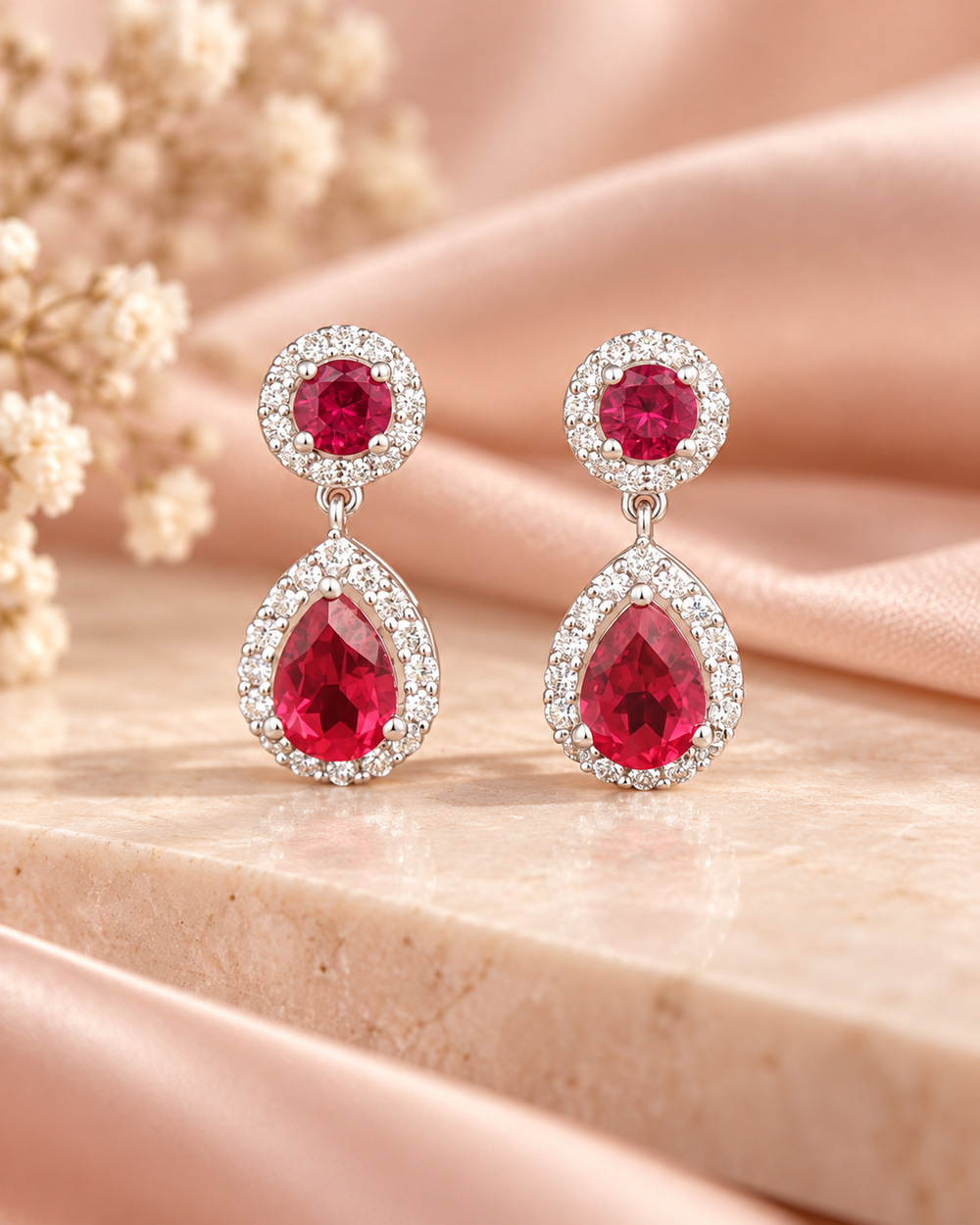 Red halo pear drop earrings — soft styled portrait image