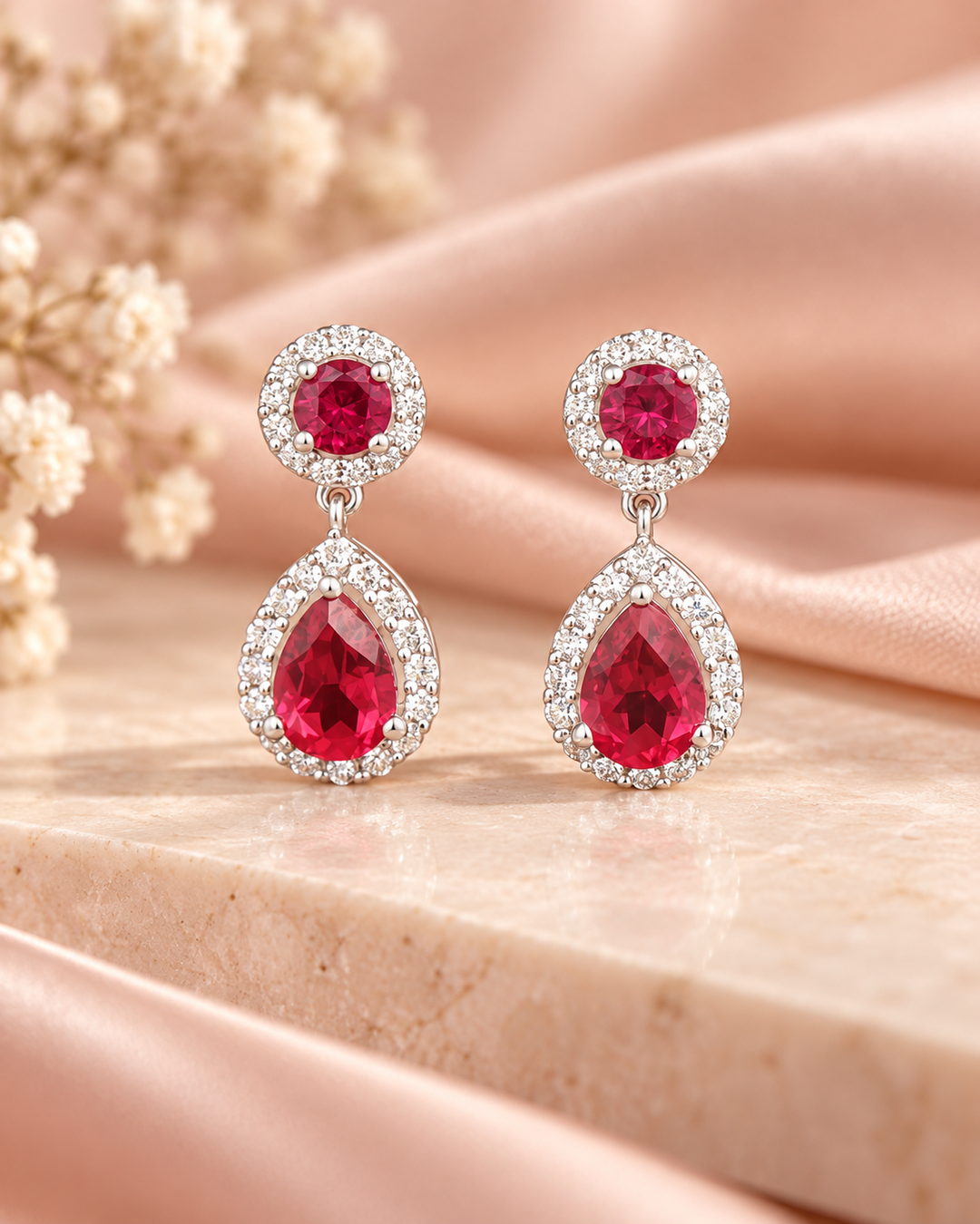 Red halo pear drop earrings — soft styled portrait image