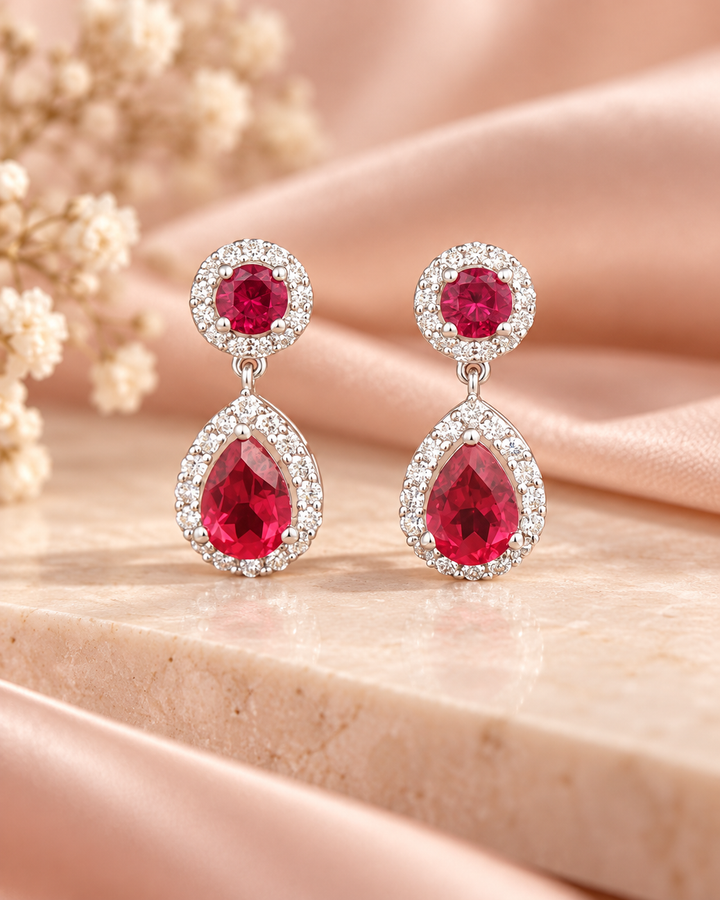 Red halo pear drop earrings — soft styled portrait image