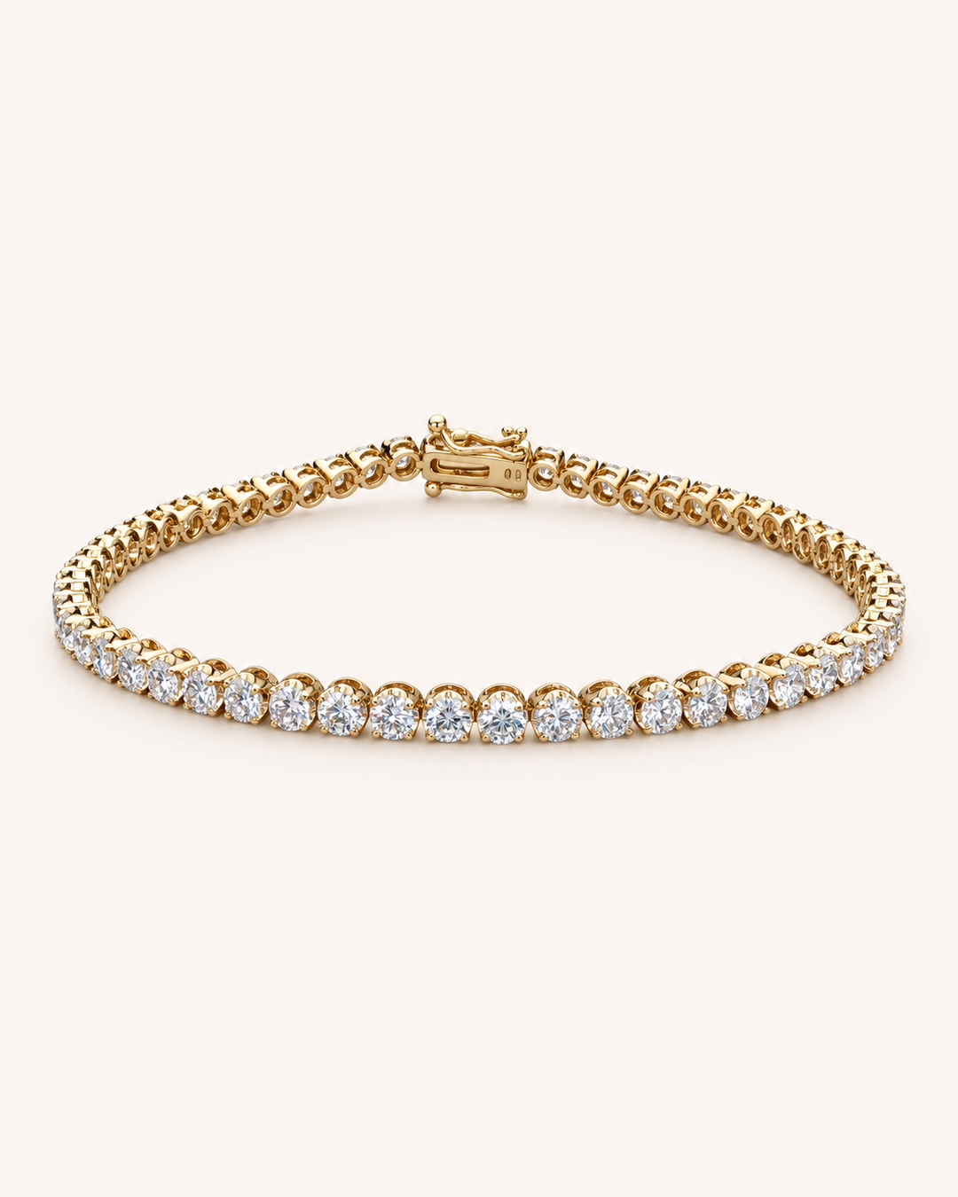 Crown-set lab-grown diamond tennis bracelet in yellow gold on soft cream background