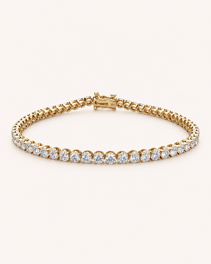 Crown-set lab-grown diamond tennis bracelet in yellow gold on soft cream background